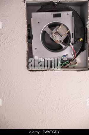 Open cover of a ceiling fan in a bathroom in order to replace a broken unit Stock Photo
