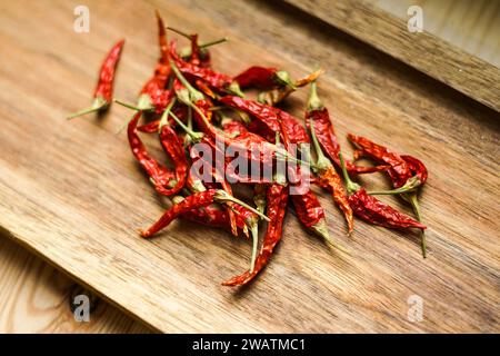 Red chilli peppers on the wooden board. Stock Photo