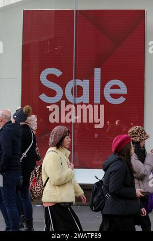 London, UK. 17th Dec, 2023. Shoppers walk past a sale sign in a store on Oxford Street in central London as the winter sales begins. (Credit Image: © Steve Taylor/SOPA Images via ZUMA Press Wire) EDITORIAL USAGE ONLY! Not for Commercial USAGE! Stock Photo