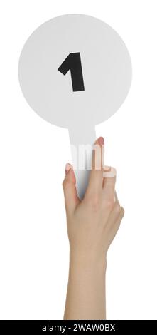 Woman holding auction paddle with number 1 on white background, closeup Stock Photo