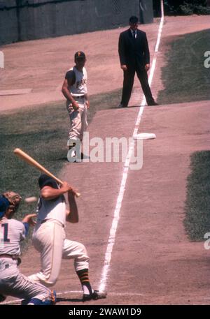 PITTSBURGH, PA - JUNE 26:  Gino Cimoli #20 of the Pittsburgh Pirates is knocked down by the pitch as teammate Rocky Nelson #14 leads off of third base during an MLB game against the Chicago Cubs on June 26, 1960 at Forbes Field in Pittsburgh, Pennsylvania.  (Photo by Hy Peskin) *** Local Caption *** Gino Cimoli Stock Photo