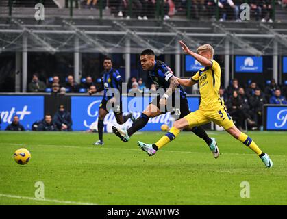 Milan, Italy. 6th Jan, 2024. Lautaro Martinez (L) of FC Inter scores during the Serie A 19th round football match between FC Inter and Hellas Verona in Milan, Italy, Jan. 6, 2024. Credit: Alberto Lingria/Xinhua/Alamy Live News Stock Photo