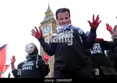 London UK 6th January 2024 Police Officers Form A Cordon On   London Uk 6th January 2024 Protesters With Bloodied Hands Wear Face Masks With The Photos Of David Cameron Benjamin Netanyahu And Rishi Sunak Around A Thousand Palestine Supporters Including From Activist Groups Sisters Uncut And Blm Marched Through Westminster From St Jamess Park Towards Parliament Square Where The Demonstrators Were Contained By A Police Cordon And Imposed Conditions Curtailing Further Movement Credit Eleventh Hour Photographyalamy Live News 2waw6mt 