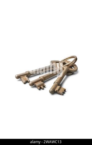 bunch of old door keys, three used metallic silver house keys isolated on white background, selective focus with copy space Stock Photo