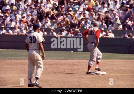 LOS ANGELES, CA - JULY 9: Joey Jay #30 of the Cincinnati Reds stands on second base as shortstop Maury Wills #30 of the Los Angeles Dodgers plays his position during an MLB game on July 9, 1961 at the Los Angeles Memorial Coliseum in Los Angeles, California.  (Photo by Hy Peskin) *** Local Caption *** Joey Jay;Maury Wills Stock Photo