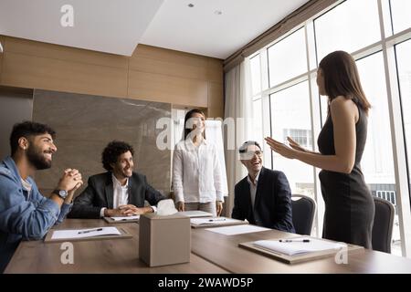 Cheerful multiethnic business professional colleagues working on project together Stock Photo