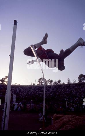 PALO ALTO, CA - JULY 1:  General view of a silhouetted high jumper using the straddle technique as he knocks off the bar with his jump during the 1960 U.S. Olympic Track and Field Trials on July 1, 1960 at Stanford Stadium in Palo Alto, California.  (Photo by Hy Peskin) Stock Photo