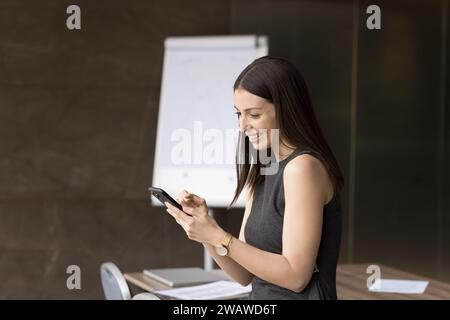 Cheerful attractive Latin business professional woman using online service Stock Photo
