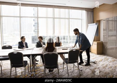 Young Arab project manager man presenting startup to colleagues Stock Photo