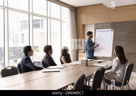 Young Arab project manager presenting marketing plan to team Stock Photo