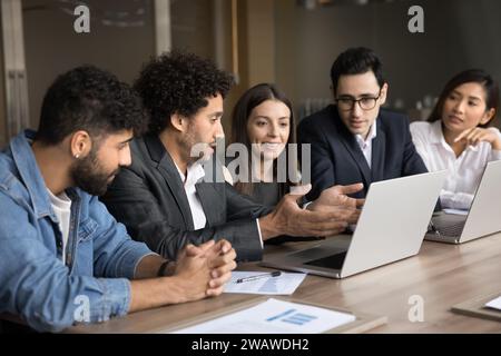Young Arab project manager man presenting creative ideas to team Stock Photo