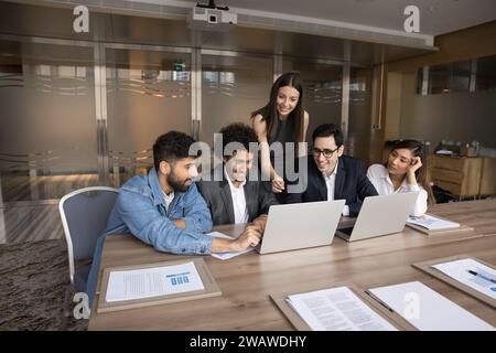 Multiethnic business team of happy colleagues using laptop for teamwork Stock Photo