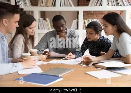Focused diverse multiracial students work on group project Stock Photo