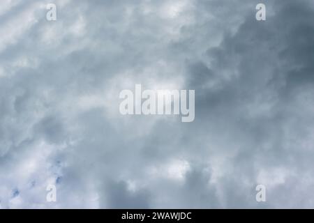 Full frame shot of dramatic sky and dark rain clouds. sun shines through the clouds. Stock Photo