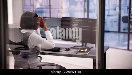 Business Engineer Analyzing Broken Code on Computer Screen Stock Photo