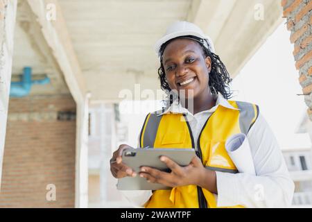 Portrait smart success black women worker african female work in construction industry happy smile in construction site. Stock Photo