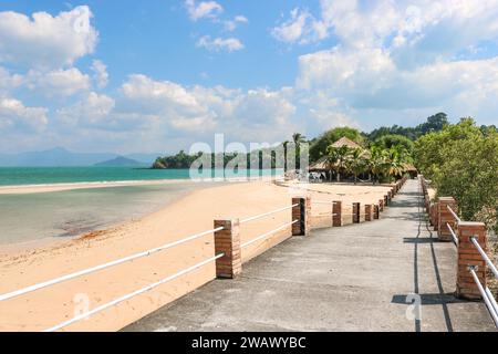 A bridge along the coast leading to a resort on a tropical island. Vacation, travel, relaxation concept. Stock Photo