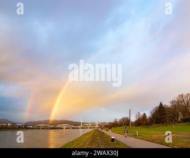 Linz: double rainbow over river Donau (Danube), way at Donaulände, bridge Eisenbahnbrücke, bridge VOEST-Brücke (behind) in Zentralraum, Oberösterreich Stock Photo