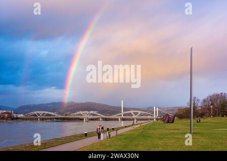 Linz: rainbow over river Donau (Danube), way at Donaulände, bridge Eisenbahnbrücke, bridge VOEST-Brücke (behind) in Zentralraum, Oberösterreich, Upper Stock Photo