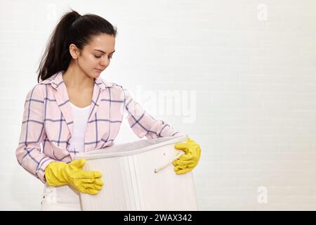Woman is holding basket with laundry, copy space Stock Photo