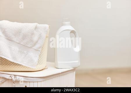 washing gel or laundry detergent on white laundry basket. Mock up, copy space. Stock Photo