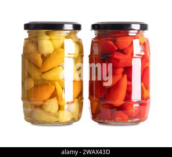 Yellow and red hot baby peppers pickled in glass jars. Two glasses with small hot chilis or pepperonis, pasteurized and preserved in a brine. Stock Photo