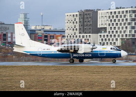 Ukrainian airline's Motor Sich Antonov An-24RV regional aircraft taxiing on the runway for takeoff from Lviv Airport Stock Photo