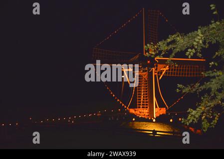 Enkhuizen, Netherlands. October 28, 2023. An old wind mill, beautiful illuminated at night.. High quality photo Stock Photo