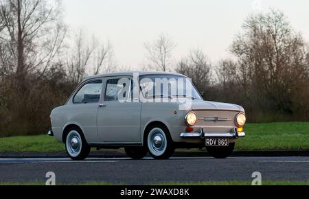 Stony Stratford,UK Jan 1st 2024.1969 beige Fiat 850 car arriving at Stony Stratford for the annual New Years Day vintage and classic vehicle festival. Stock Photo