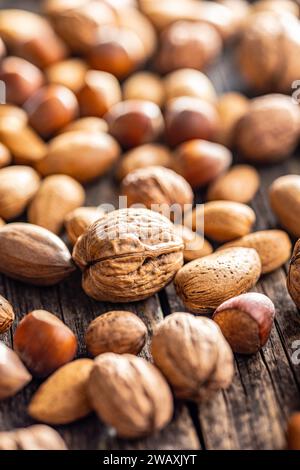 A mix of different nuts on the wooden table. Stock Photo