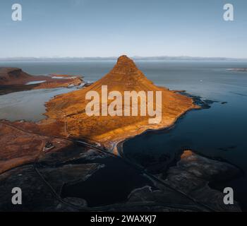 Beautiful aerial view of the Kirkjufell high mountain in Iceland, on the Snaefellsnes peninsula. Sunset Sunrise soft orange light. West Iceland. Stock Photo