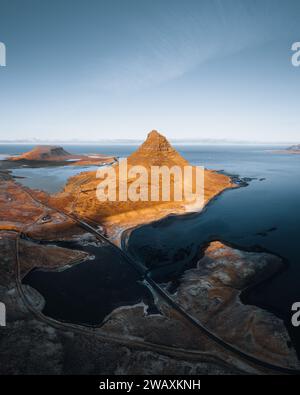 Beautiful aerial view of the Kirkjufell high mountain in Iceland, on the Snaefellsnes peninsula. Sunset Sunrise soft orange light. West Iceland. Stock Photo