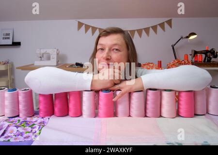 Portrait of a middle-aged woman in a sewing workshop. Stock Photo