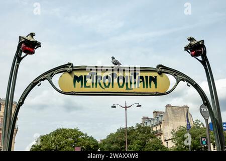 Paris Metro entrance with pigeon on the sign, France, Europe Stock Photo