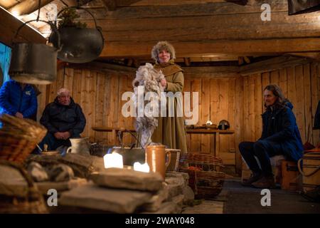 A woman dressed in Sami clothes shows some ways of preserving products ...