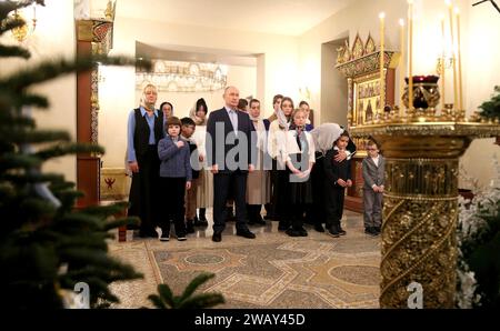 Novo-Ogaryovo, Russia. 07th Jan, 2024. Russian President Vladimir Putin attends an Orthodox Christmas service at the Church of the Icon of Savior Not Made by Hands at the official presidential residence of Novo-Ogaryovo, January 7, 2024 in Novo-Ogaryovo, Moscow Oblast, Russia. Putin hosted families of soldiers killed in the Ukraine war for the celebration. Credit: Gavriil Grigorov/Kremlin Pool/Alamy Live News Stock Photo