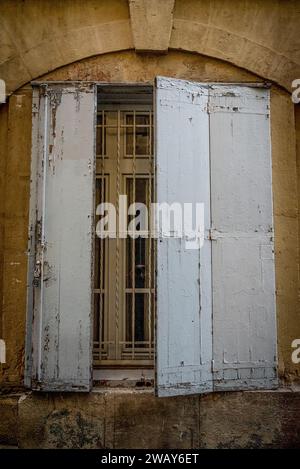 Half open wooden window shutters on an old house,  Montpellier, France Stock Photo