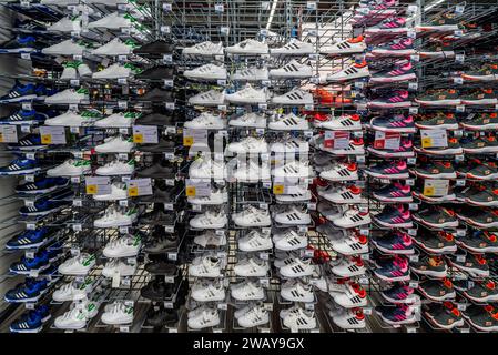 Italy - November 15, 2023: Adidas Grand Court sneakers and tennis shoes displayed on shelves for sale in Italian Decathlon Store Stock Photo
