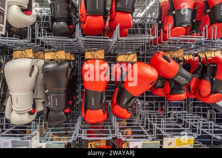 Italy - November 15, 2023: Boxing gloves displayed on shelves for sale in Italian Decathlon store Stock Photo
