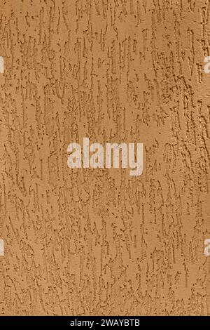 Beige-orange sand plaster wall texture background, vertical photo. Stock Photo
