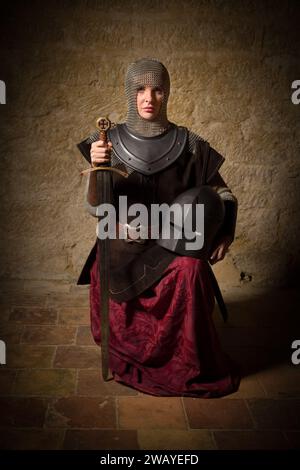 Reenactment scene of a female medieval knight in armor depicting the legenary Joan of Arc Stock Photo