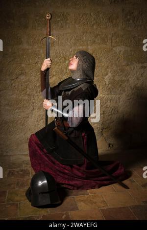 Reenactment scene of a female medieval knight in armor depicting the legenary Joan of Arc Stock Photo