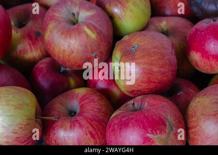 Red apples background. Red ripe apple fruits in the market. Winter harvest. Sweet juicy fruits. Garden harvest. Raw food. Stock Photo