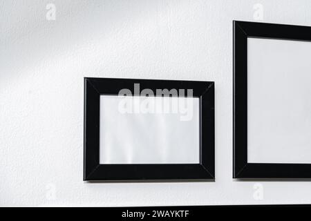 Set of black frames on white wall with copy space Stock Photo