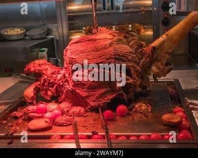 Leg of roast lamb being served in the Marketplace Buffet on the MSC Euribia sailing in Northern Europe (July 23). Stock Photo