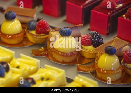Pastries in rows in various colors in the pastry shop Stock Photo