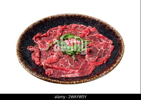 Carpaccio marbled beef meat with arugula and pomegranate seeds. Isolated on white background, top view Stock Photo