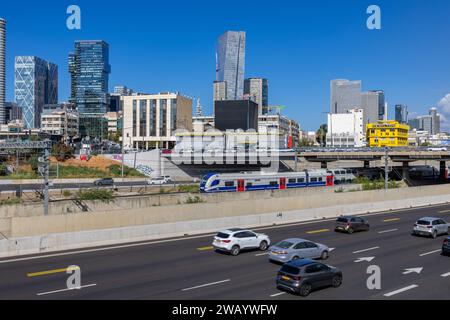 Tel Aviv Israel. November 15, 2023. Cars at Ayalon routes, Derech Hashalom. Bridge, train and modern buildings in the business area Stock Photo