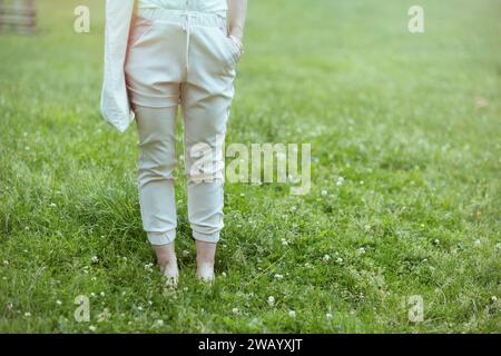 Summer time. Closeup on woman in the meadow in the city park. Stock Photo