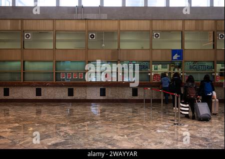 Palermo, Sicily, Italy, December 14, 2023 - Travellers waiting at the ticket boot in the central railway station Stock Photo